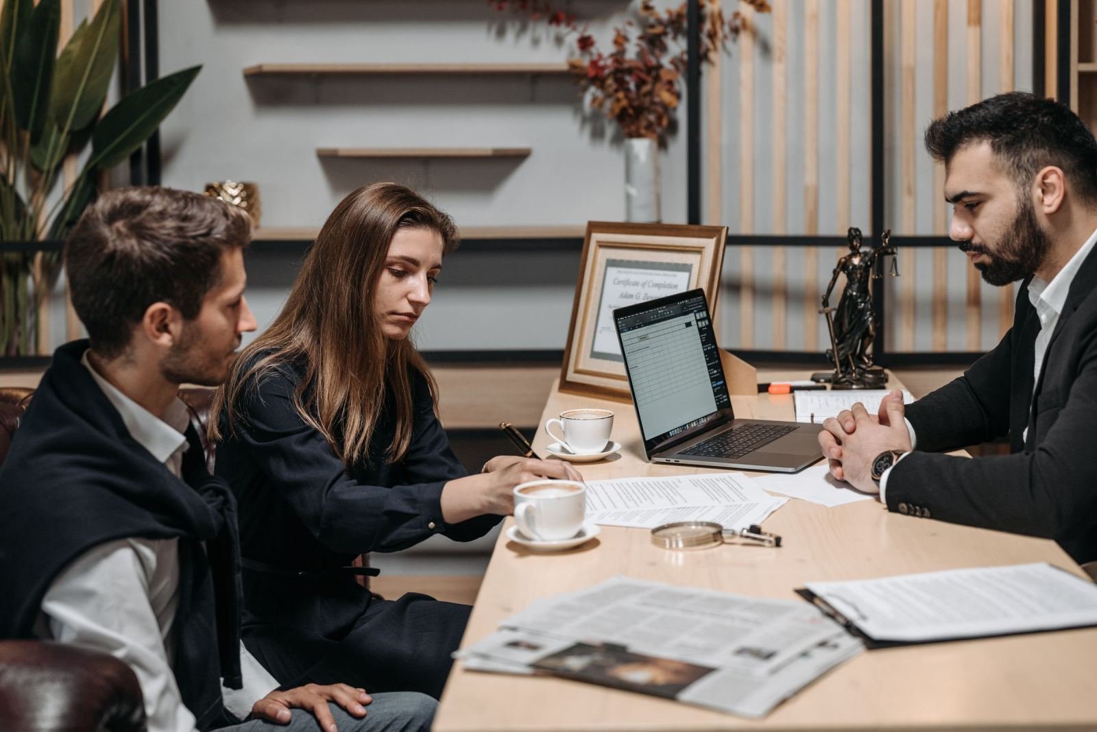 In a bright office, a couple talks through options with a professional.