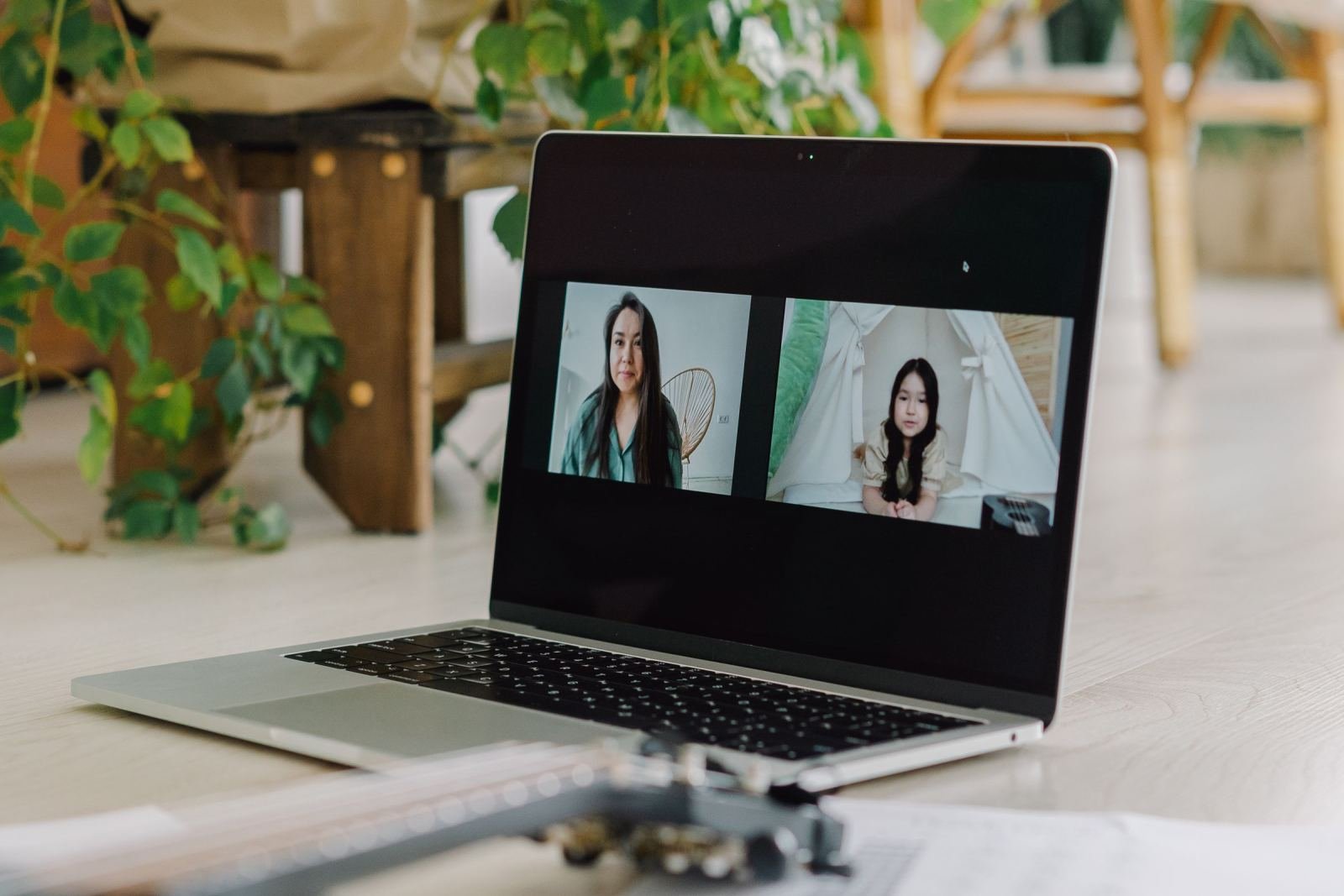 A laptop screen showing a video call between two women